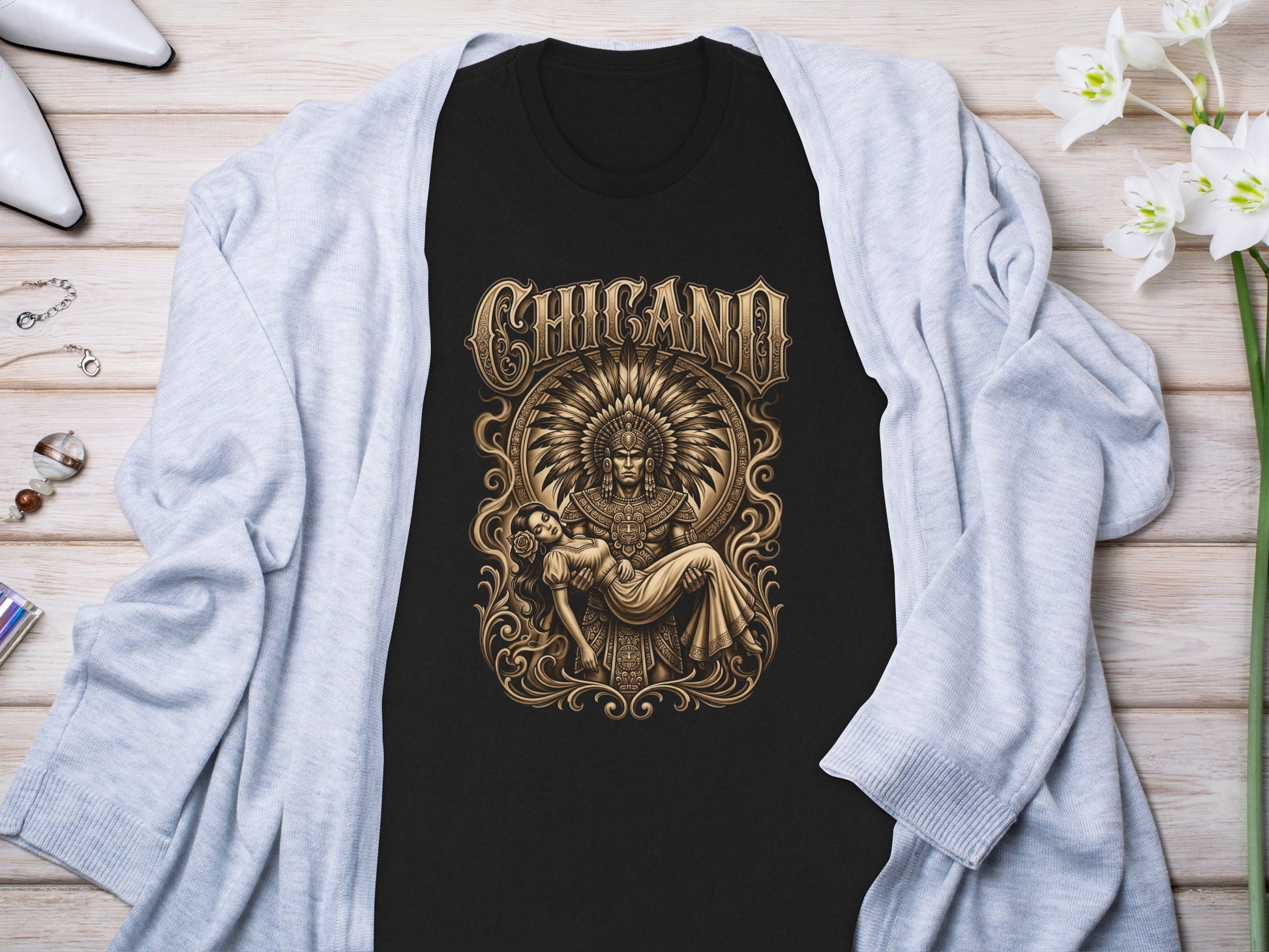 Black t-shirt with gold Chicana warrior and woman illustration.