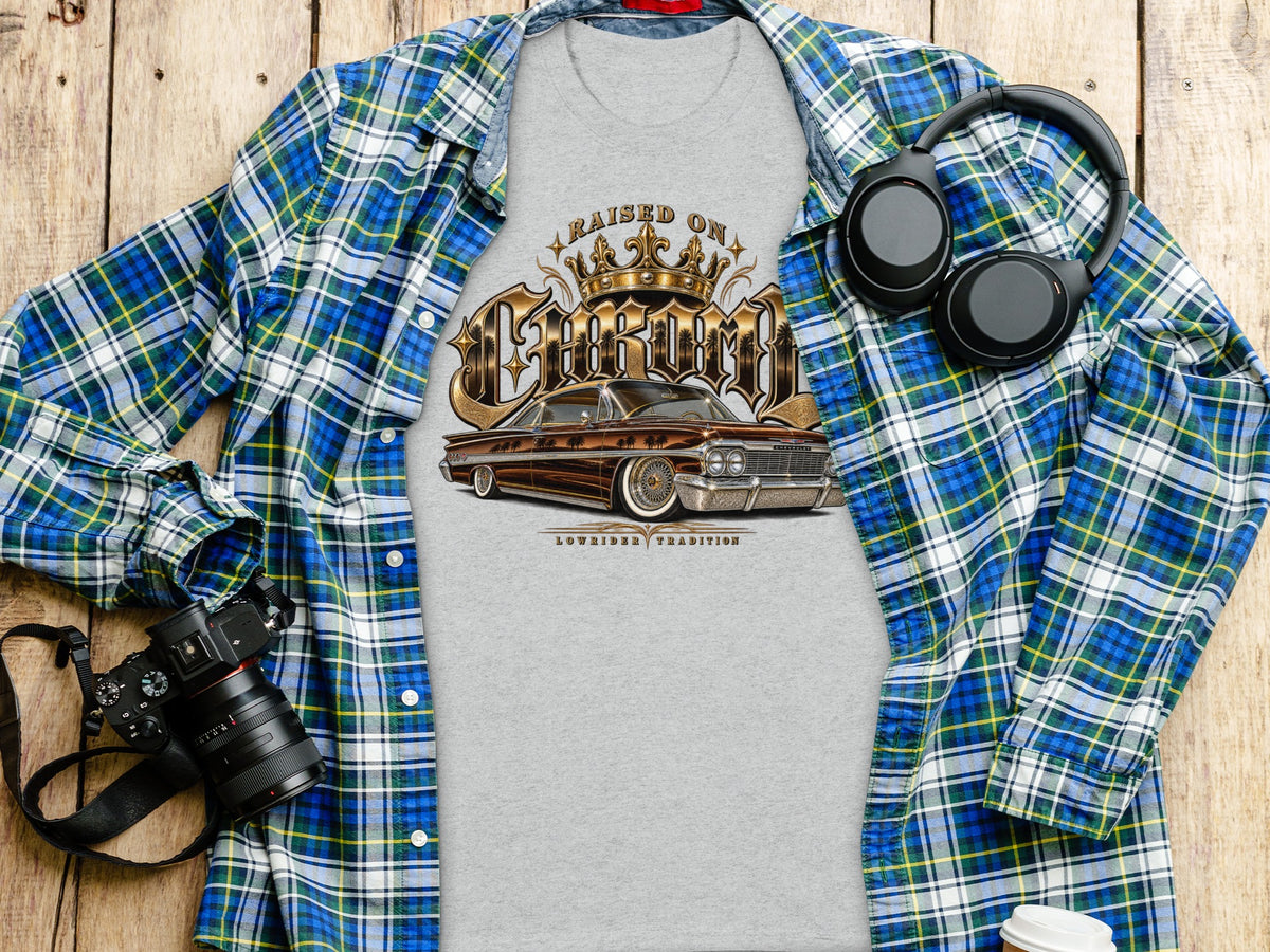 Grey t-shirt with "Raised on Chrome Lowrider Tradition" and a vintage car graphic.