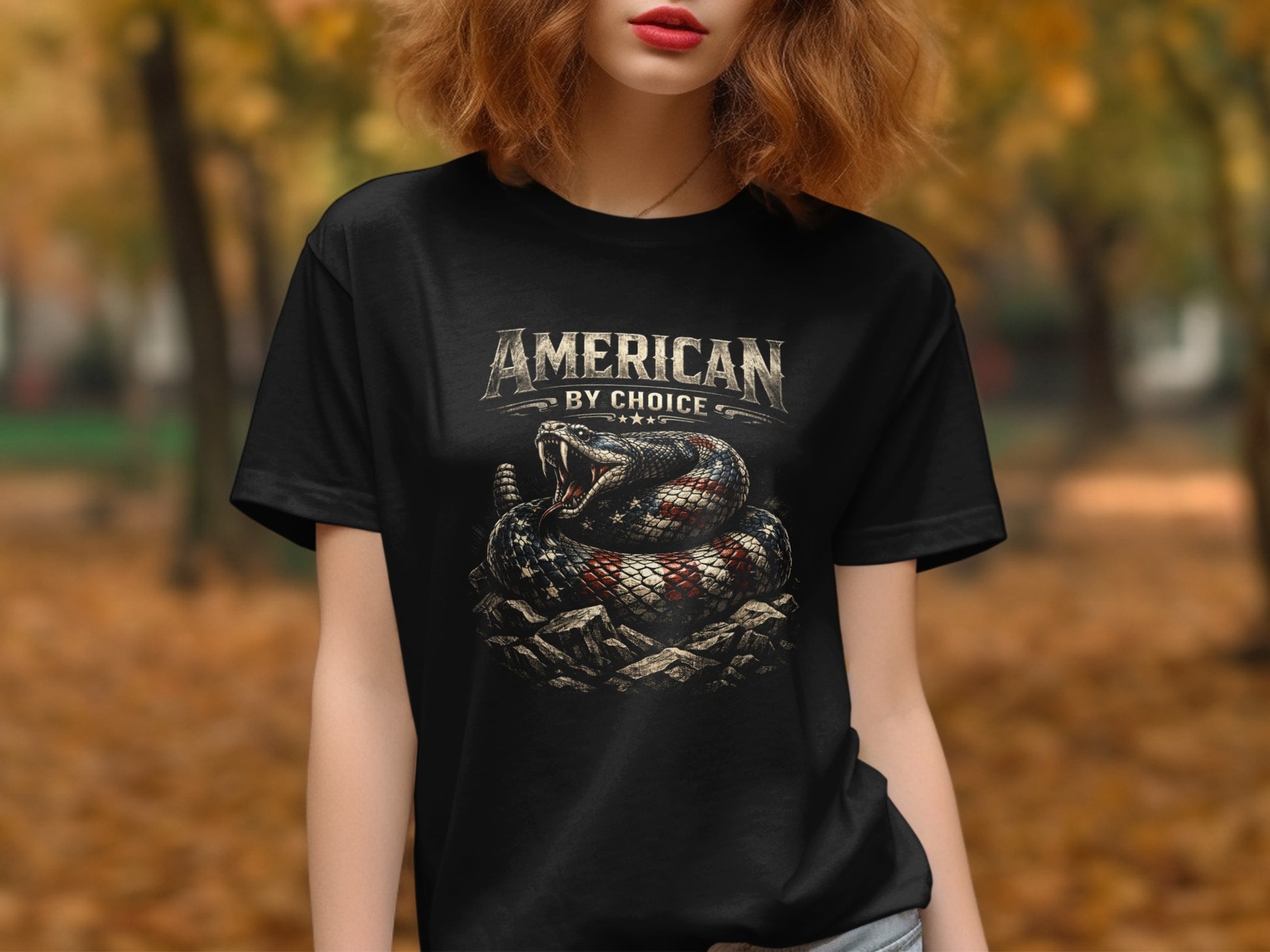 Black t-shirt with American by Choice text and a coiled rattlesnake on rocks.