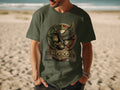 Man wearing olive green t-shirt with circular Mexico eagle emblem.