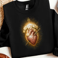 Black sweatshirt featuring a Sacred Heart design with roses and a sword.