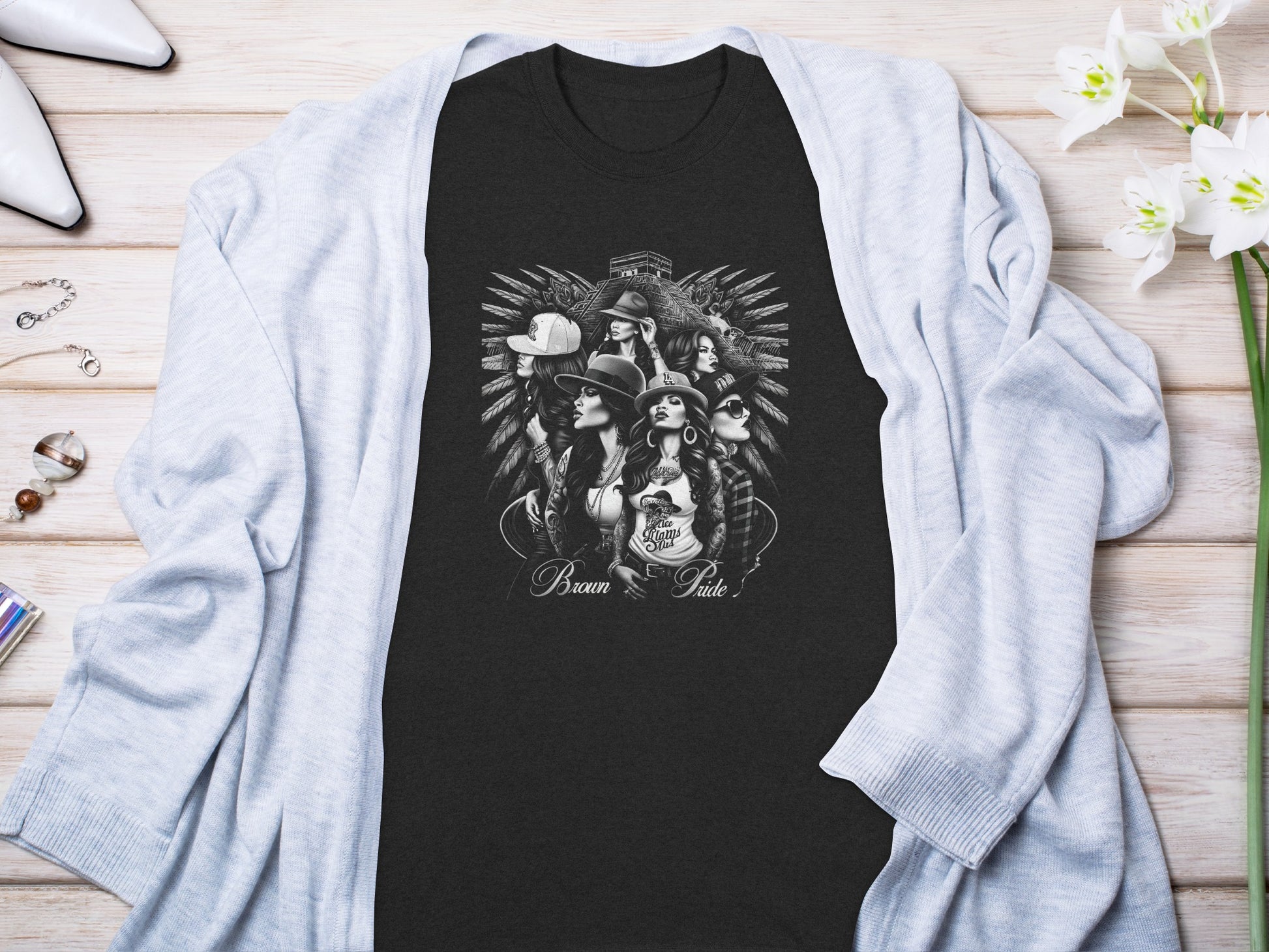 T-shirt with "Brown Pride" text and a graphic of women wearing hats.