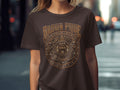 Brown t-shirt with a circular, ornate gold Aztec calendar design.