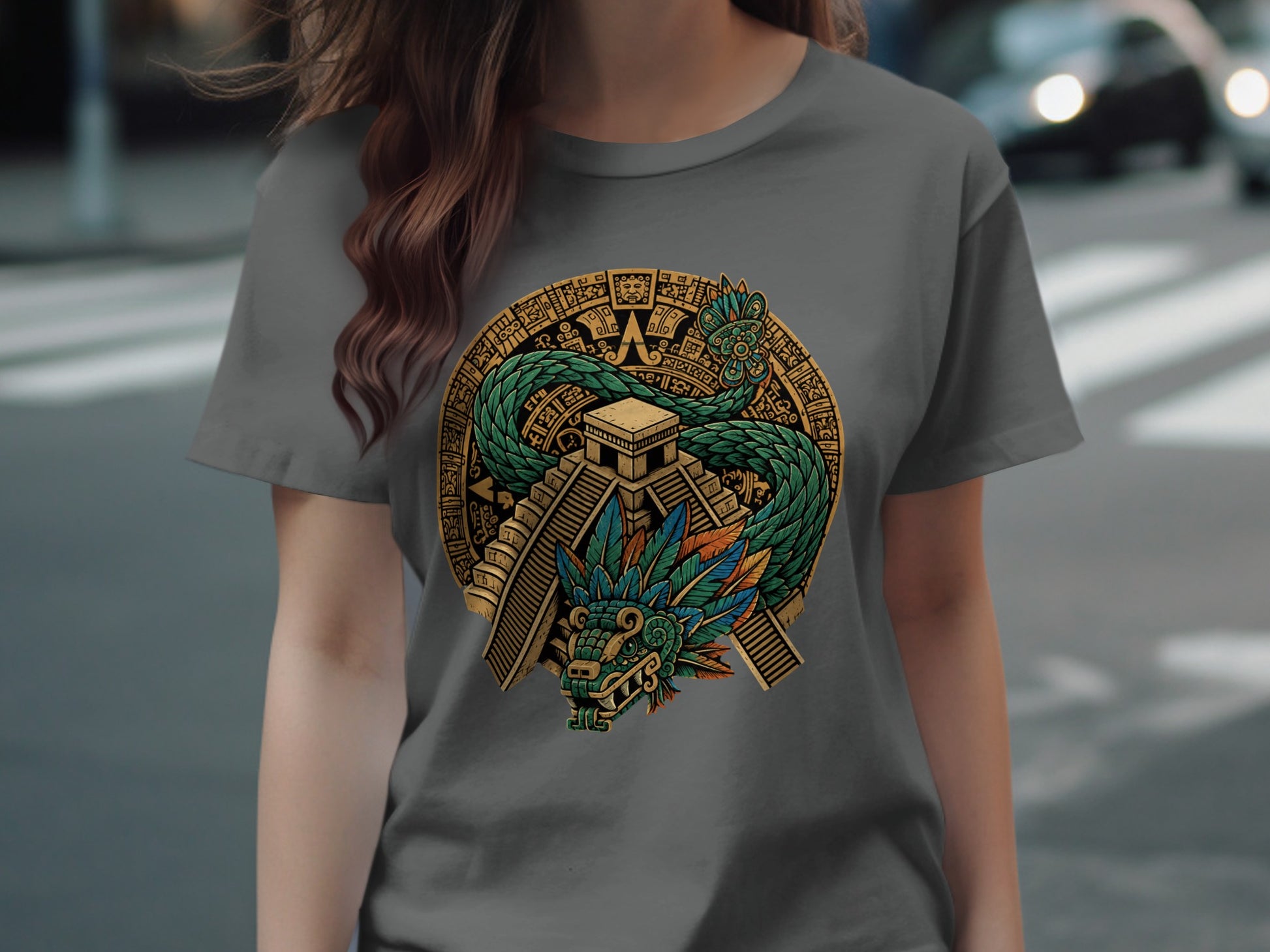 Green feathered serpent coiled around Aztec pyramid on grey t-shirt.