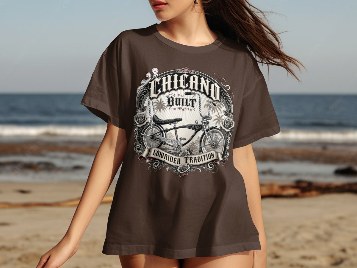 Brown t-shirt with "Chicano Built Lowrider Tradition" graphic featuring a bicycle.
