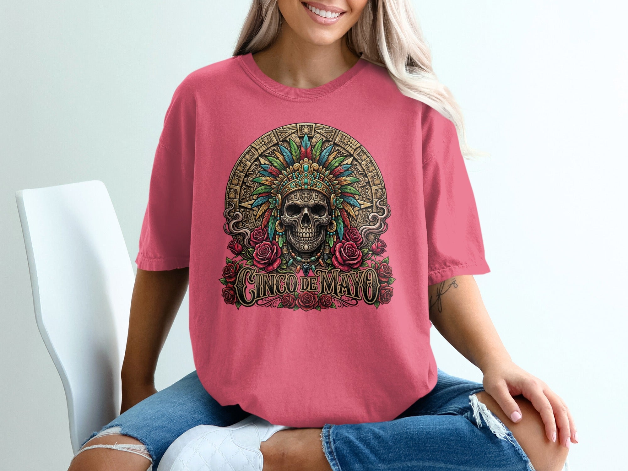 Pink t-shirt with skull, headdress, and "Cinco de Mayo" text.