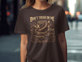 Brown t-shirt with a coiled snake, car, and 