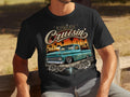 Black t-shirt graphic with turquoise lowrider truck, palm trees, sunset, and text 