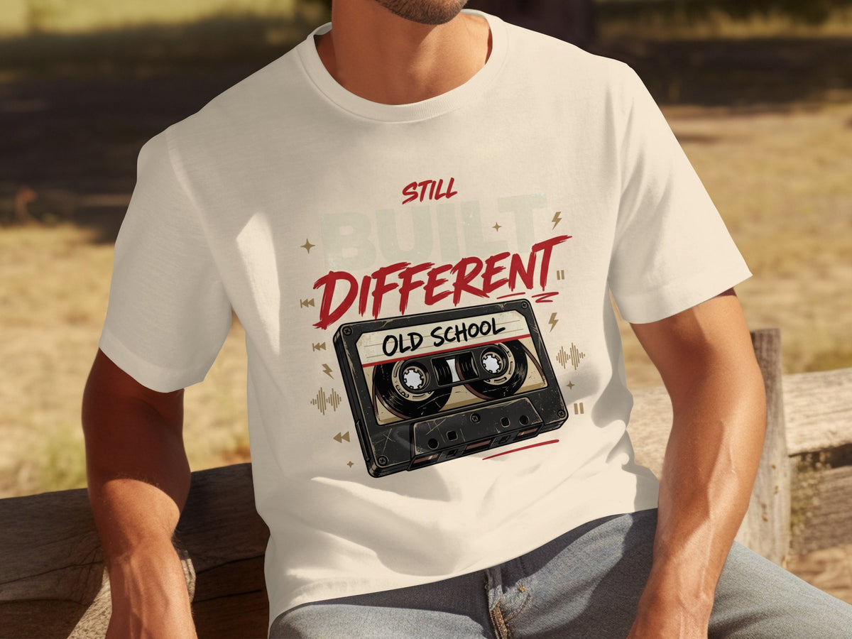 T-shirt with cassette tape graphic and text "STILL BUILT DIFFERENT OLD SCHOOL".