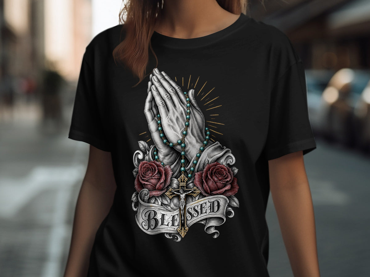 Black t-shirt with praying hands, rosary, roses, cross, and "BLESSED" text.