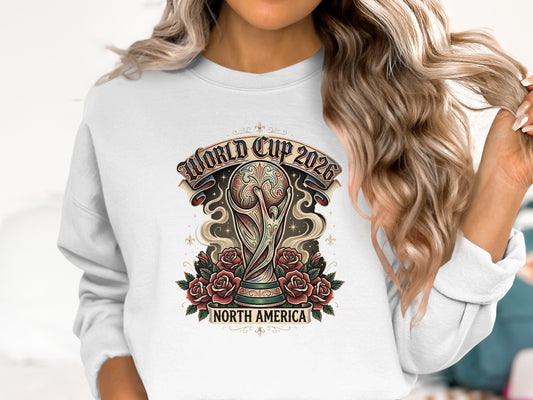 World Cup 2026 North America graphic with trophy and roses on white sweatshirt.