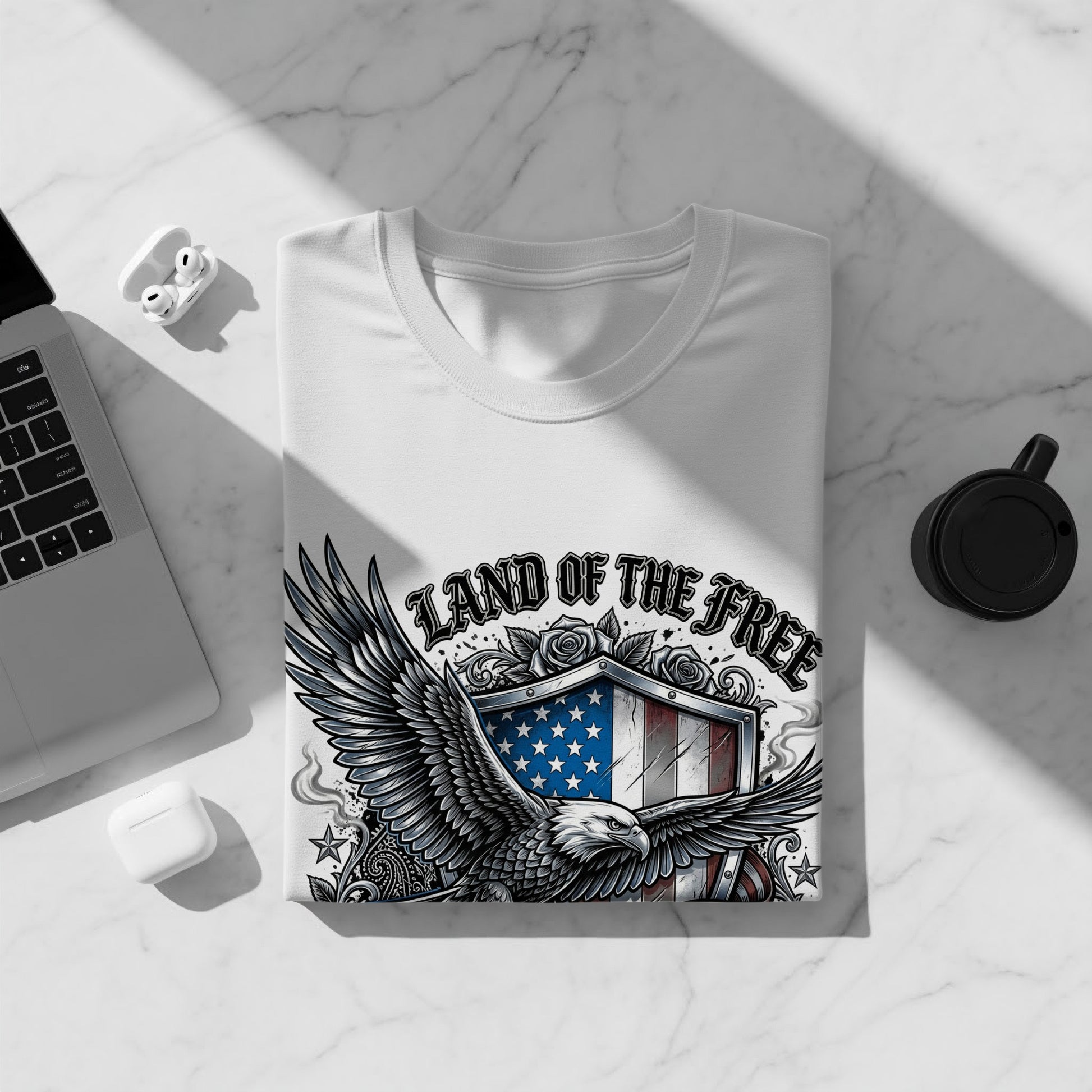 White t-shirt with Land of the Free eagle and shield graphic.