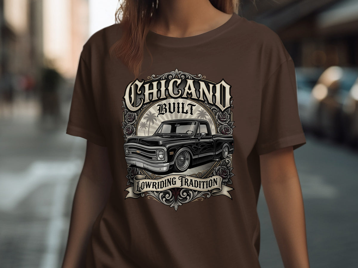 T-shirt graphic with "Chicano Built Lowriding Tradition" text and a black classic truck.