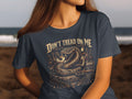 Dark t-shirt with Don't Tread On Me snake and floral design.