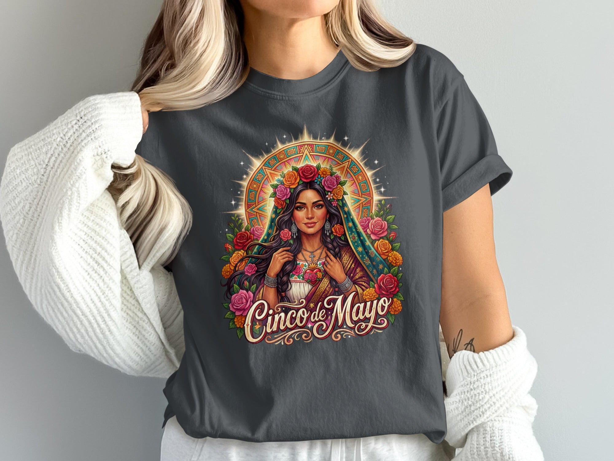 Woman wearing a t-shirt with a "Cinco de Mayo" graphic featuring a woman with flowers.