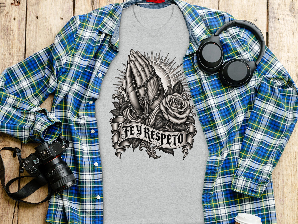 Grey t-shirt with praying hands, rosary, rose, and "Fey Respeto" text graphic.