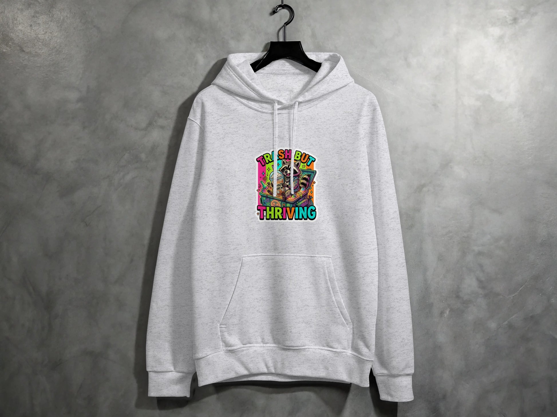 Grey hoodie with "TRASH BUT THRIVING" graphic art on chest.