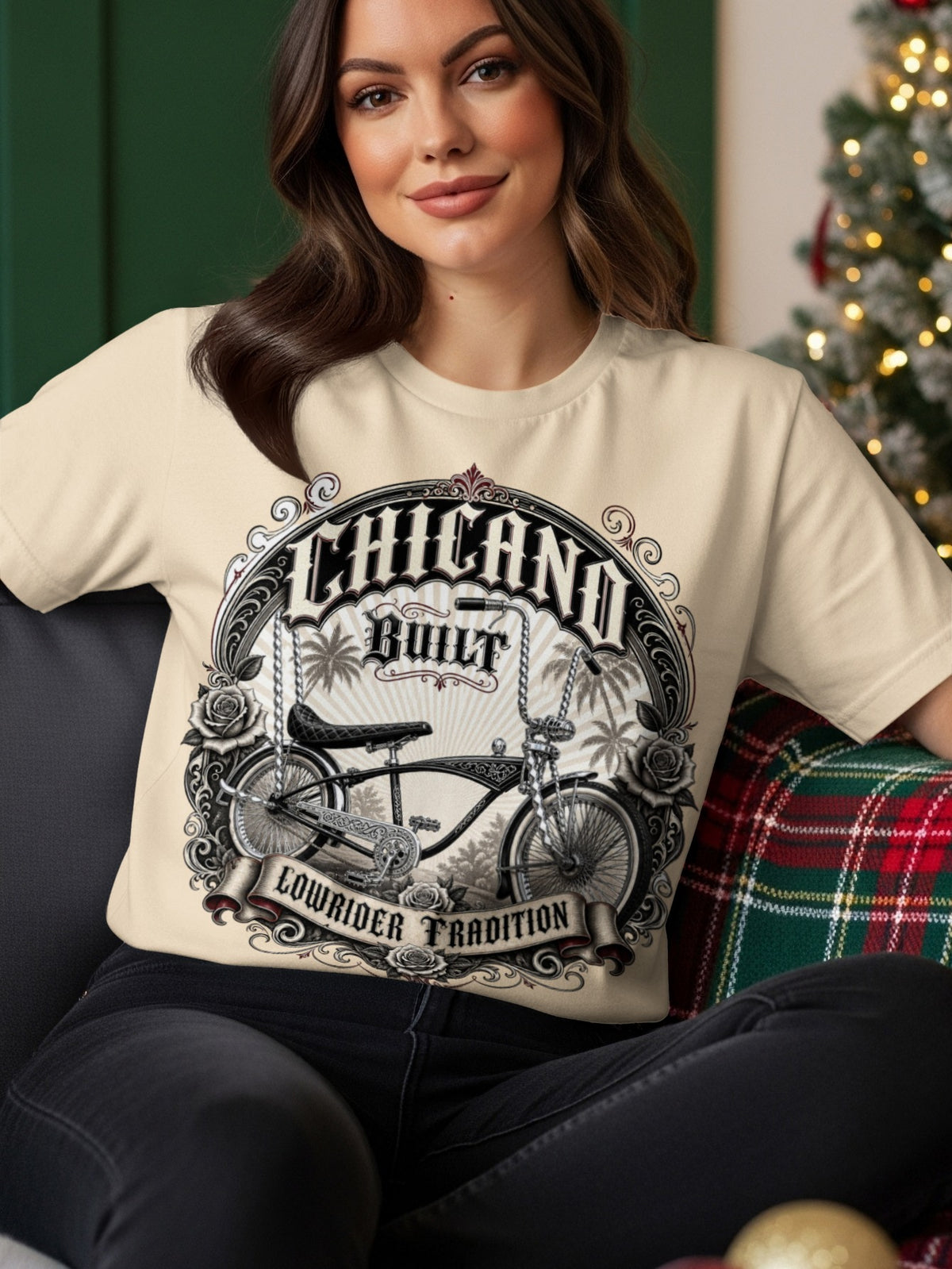 Cream t-shirt with "Chicano Built Lowrider Tradition" text and vintage bicycle graphic.
