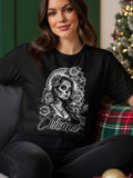 Woman wearing black t-shirt with Day of the Dead sugar skull girl graphic.