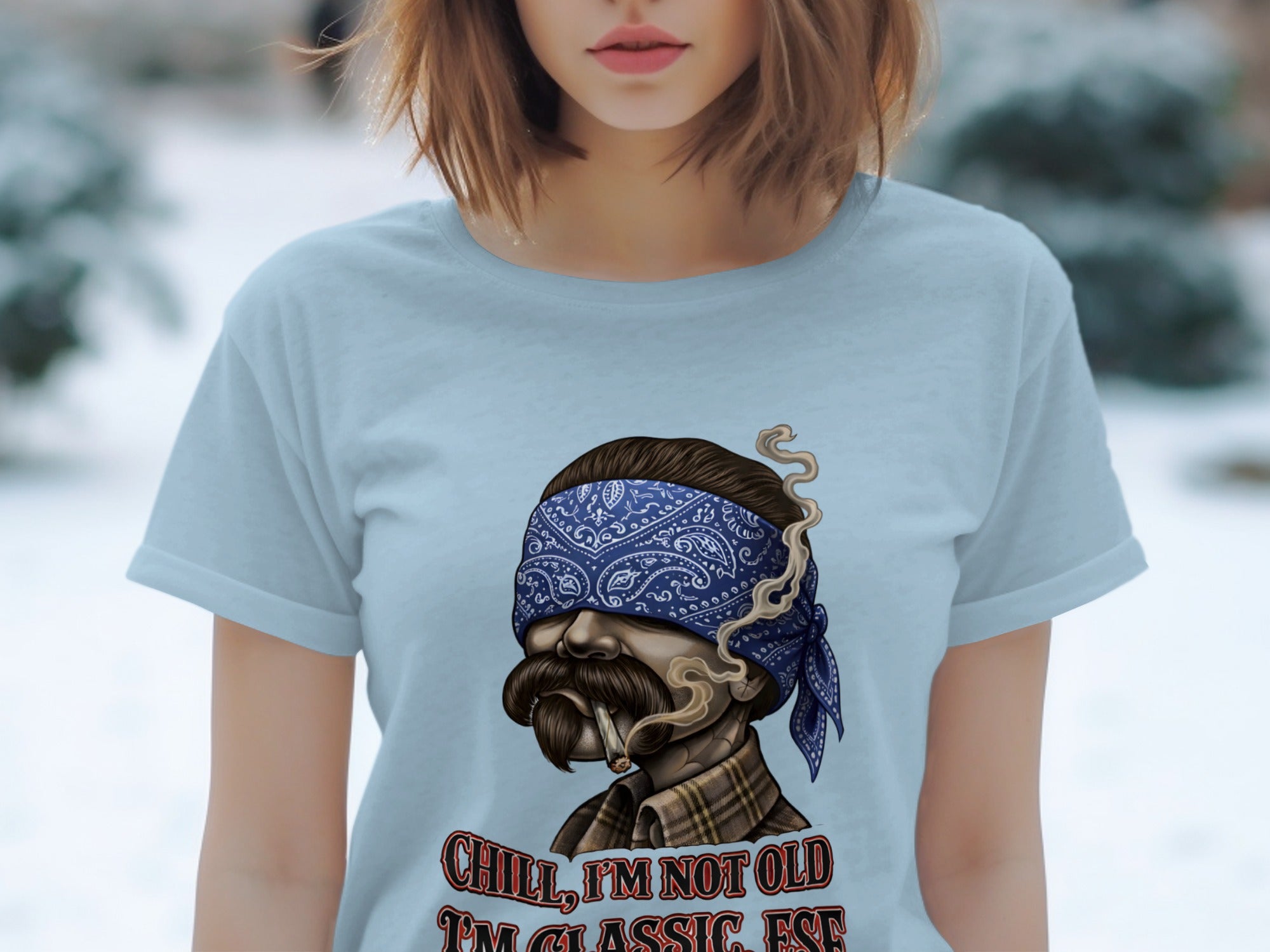 Light blue t-shirt with a man's face in a bandana, smoking a cigarette.