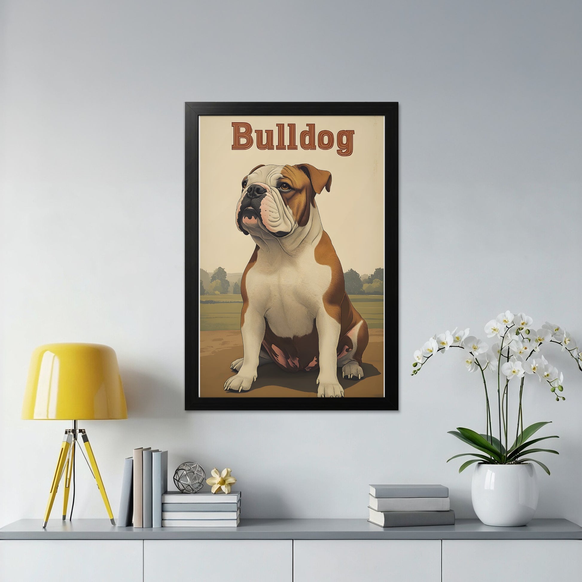 Framed poster of a brown and white bulldog sitting in a field.
