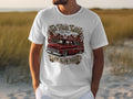 White t-shirt with a red lowrider truck graphic featuring flames and text.