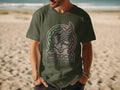 Green t-shirt with Mexico national football team crest on a beach.