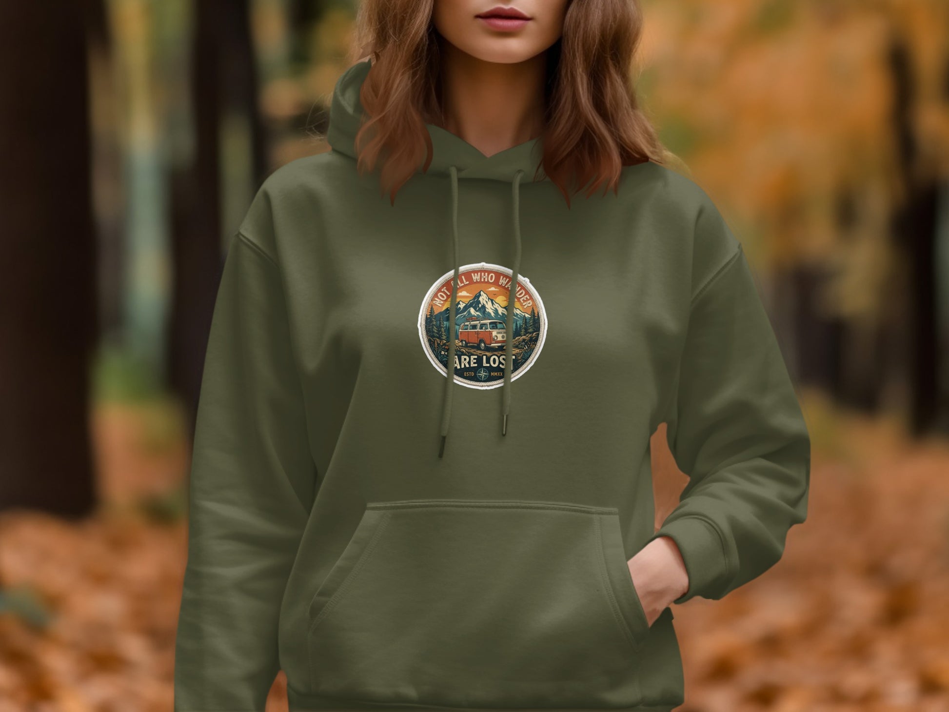 Olive green hoodie with circular graphic of mountains, trees, and van with text.