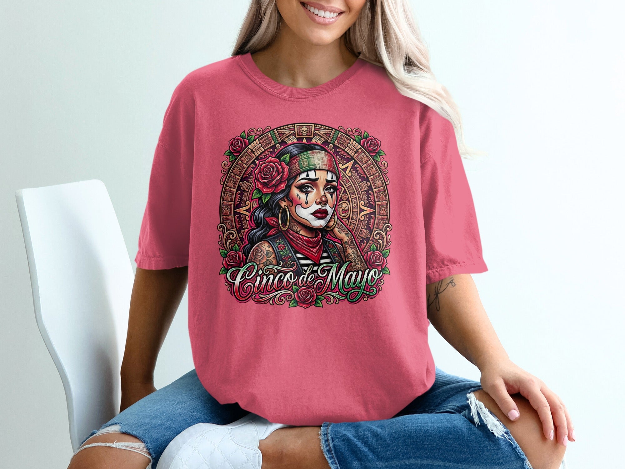 T-shirt featuring a woman with skull face paint, roses, and a Mayan calendar design.