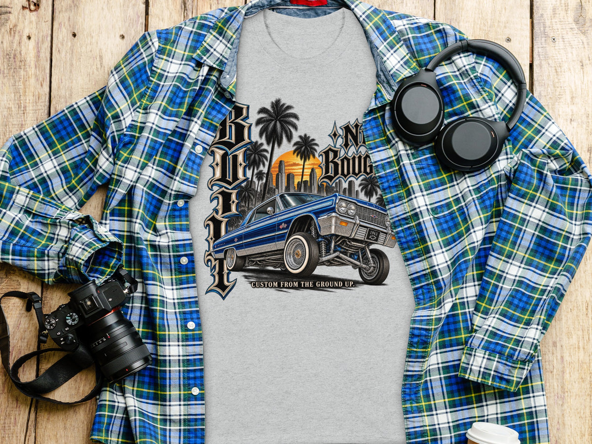 Grey t-shirt with a blue lowrider car and city skyline graphic.