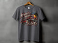 T-shirt graphic with a lowrider car, palm tree, sunset, and text 