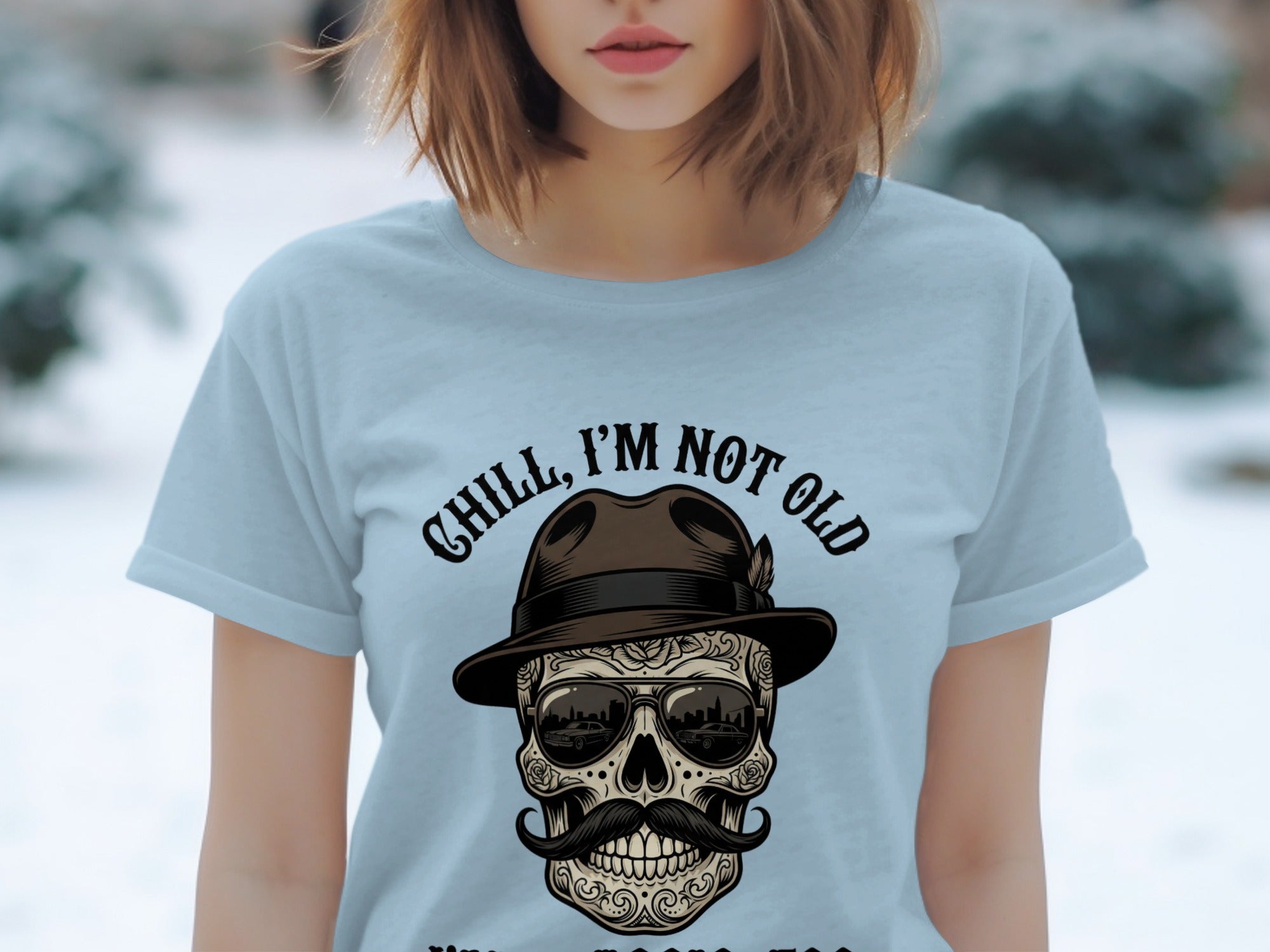 Light blue t-shirt with "Chill, I'm Not Old" text and skull graphic.