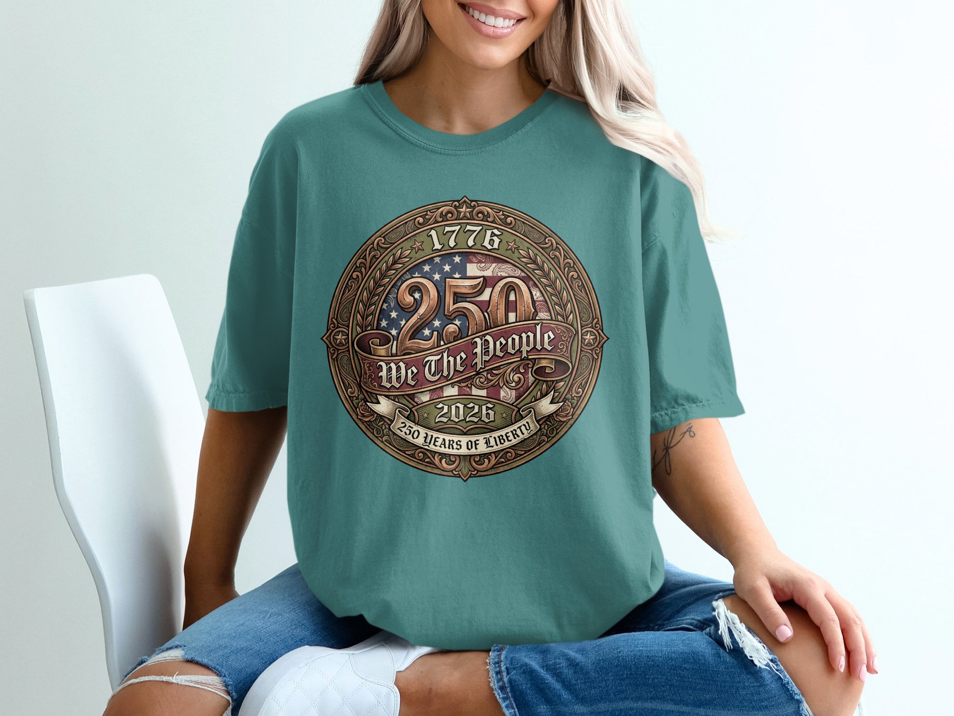 Teal t-shirt with "1776 2026 We The People 250 Years of Liberty" circular emblem.