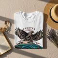 White t-shirt with eagle, snake, cacti, and vintage car graphic.