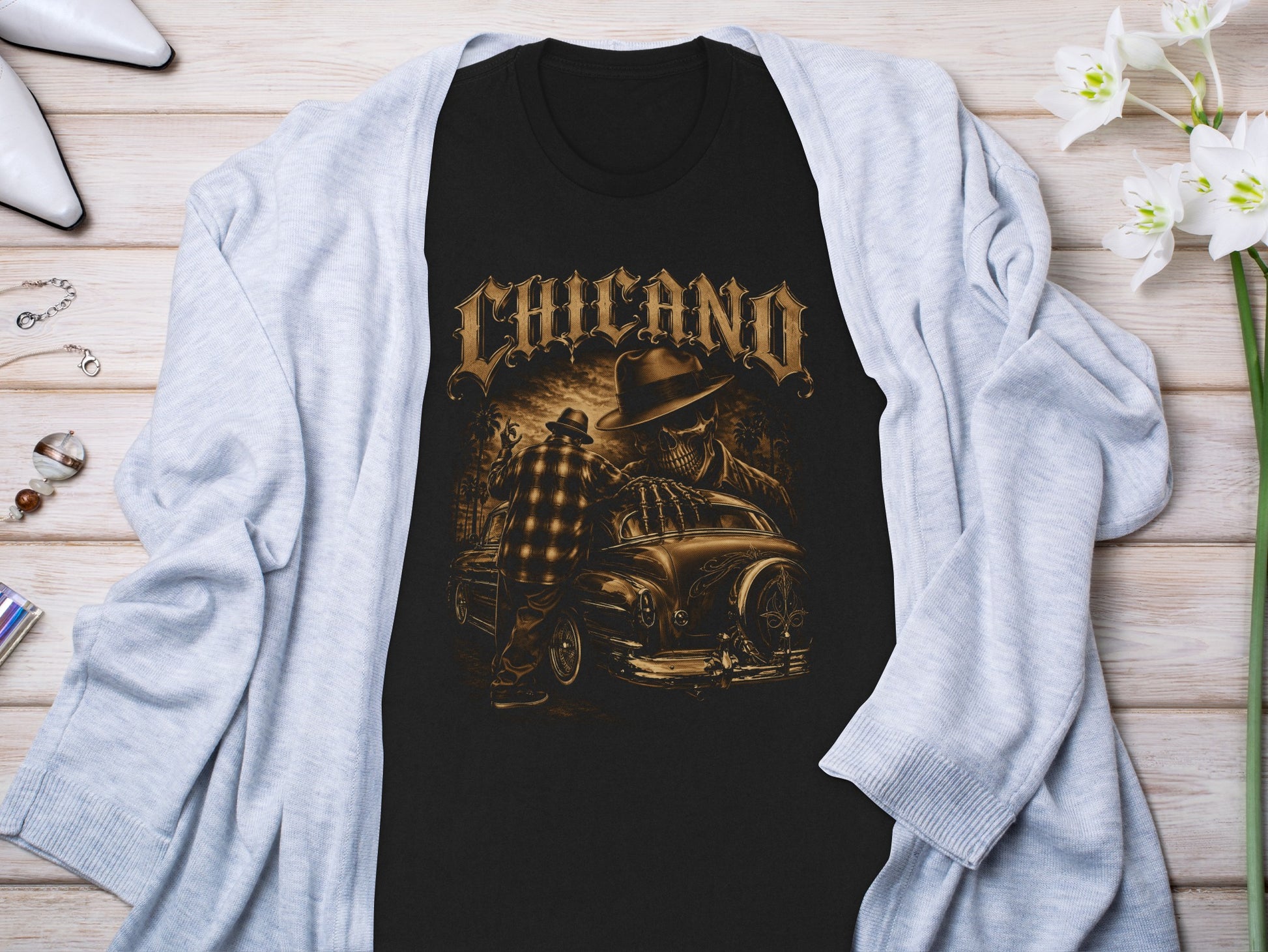 Black t-shirt with "CHICANO" text and skeleton driver in a classic car.