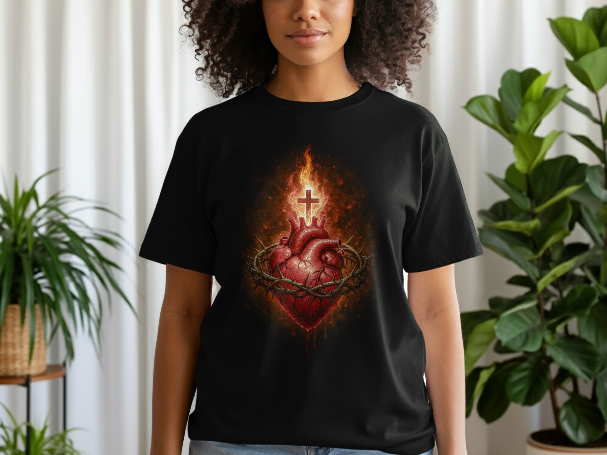 Black t-shirt featuring a bleeding heart with crown of thorns and cross.
