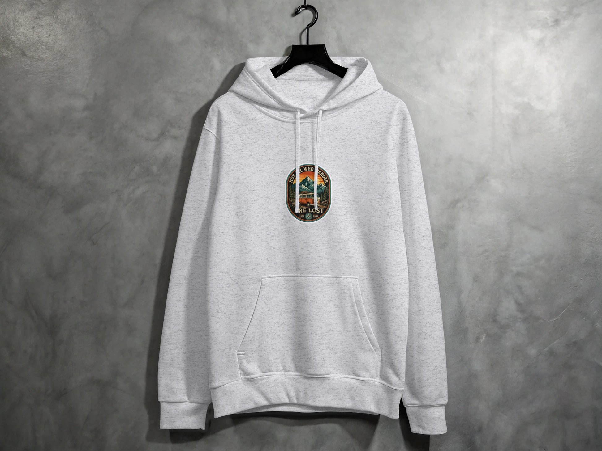 Grey hoodie with circular embroidered nature scene: mountains, trees, sun.