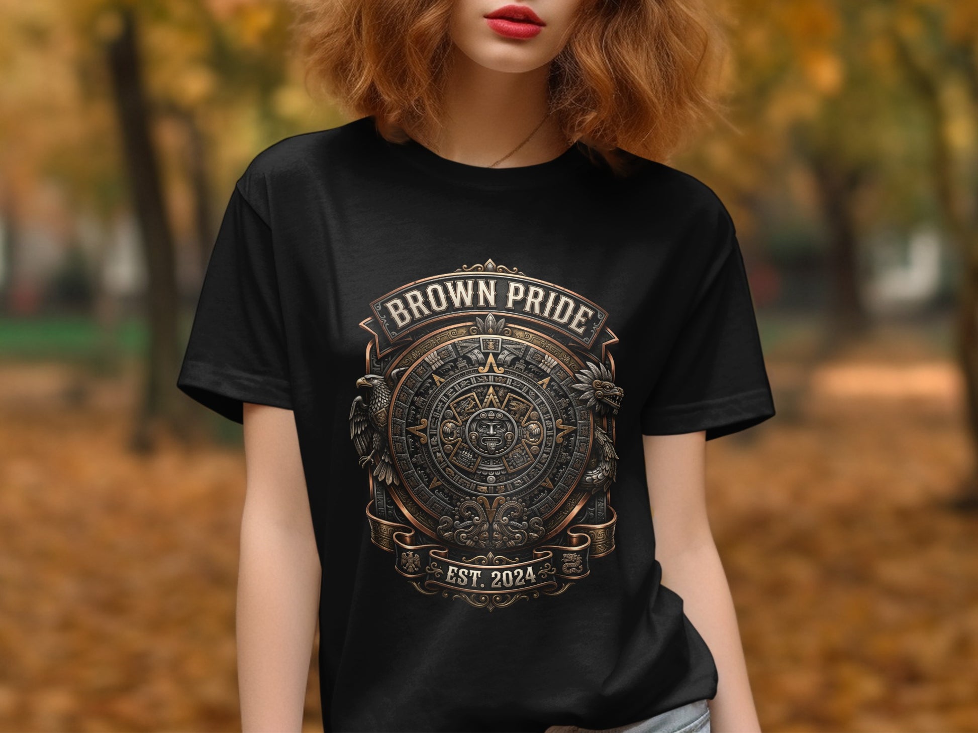 Black t-shirt with "Brown Pride" and Aztec-inspired circular design.