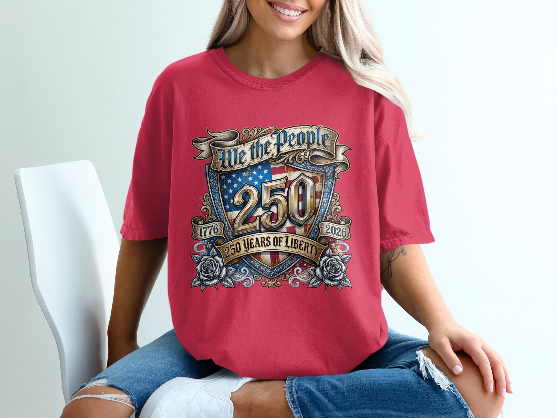 Red t-shirt with "We the People 250 Years of Liberty" and American flag emblem.