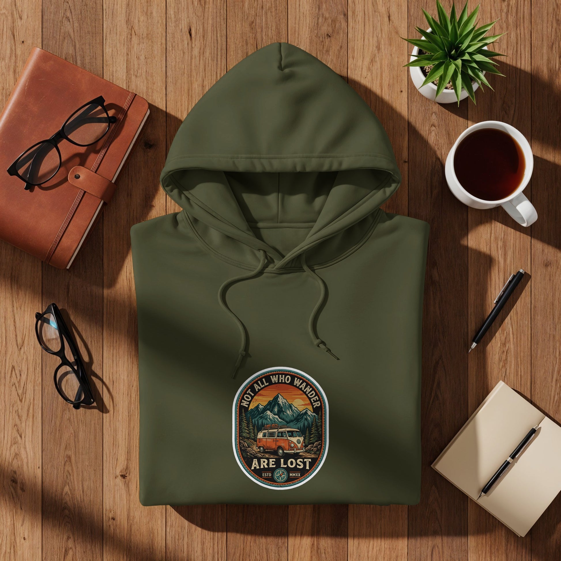 Olive green hoodie with "Not All Who Wander Are Lost" slogan and van graphic.