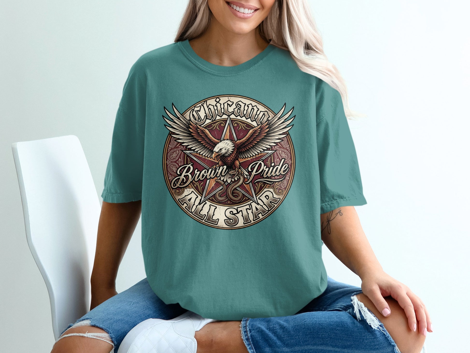 Circular graphic on t-shirt with eagle, wings spread, "Chicano Brown Pride All Star".