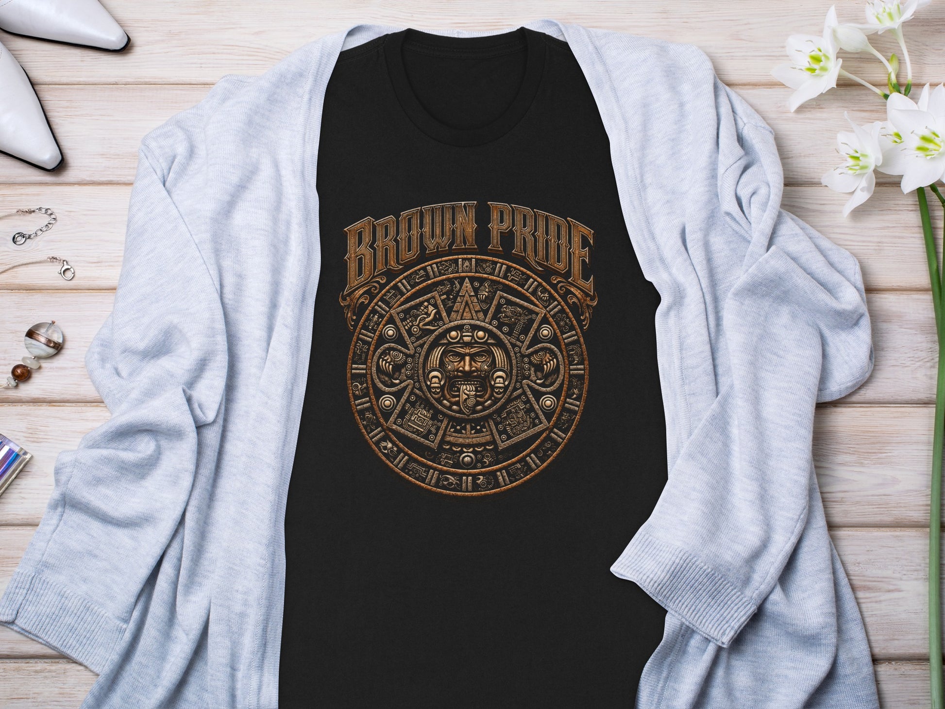 Black t-shirt with circular brown "Brown Pride" graphic of Mayan calendar design.