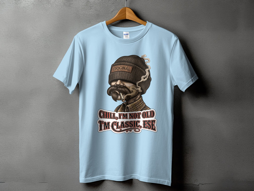 Light blue t-shirt with a distressed graphic of a man smoking, reading "Original" and "Chill, I'm Not Old. I'm Classic, Ese."