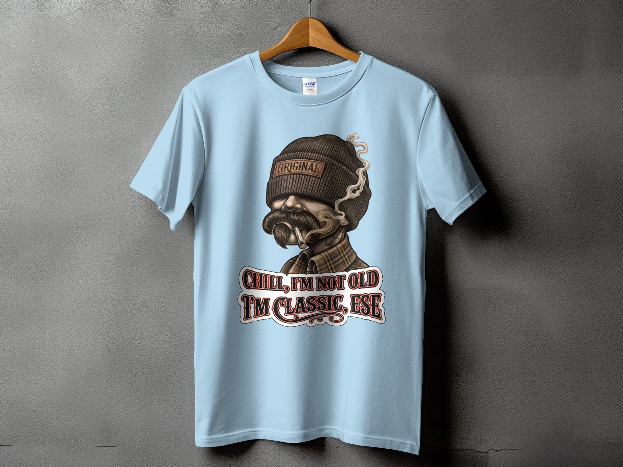 Light blue t-shirt with a distressed graphic of a man smoking, reading "Original" and "Chill, I'm Not Old. I'm Classic, Ese."