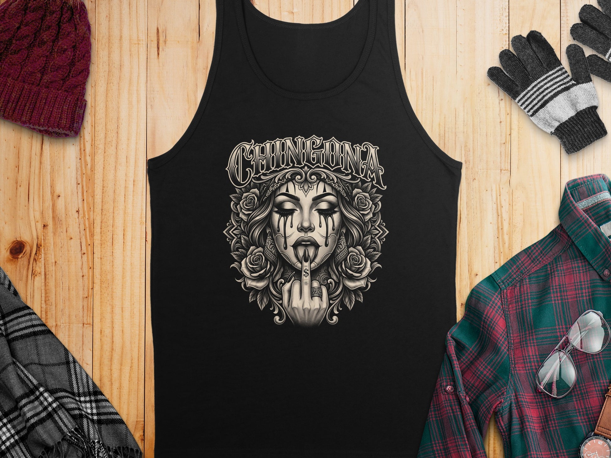 Black tank top with "CHINGONA" text and skull art, styled with gloves and a beanie.