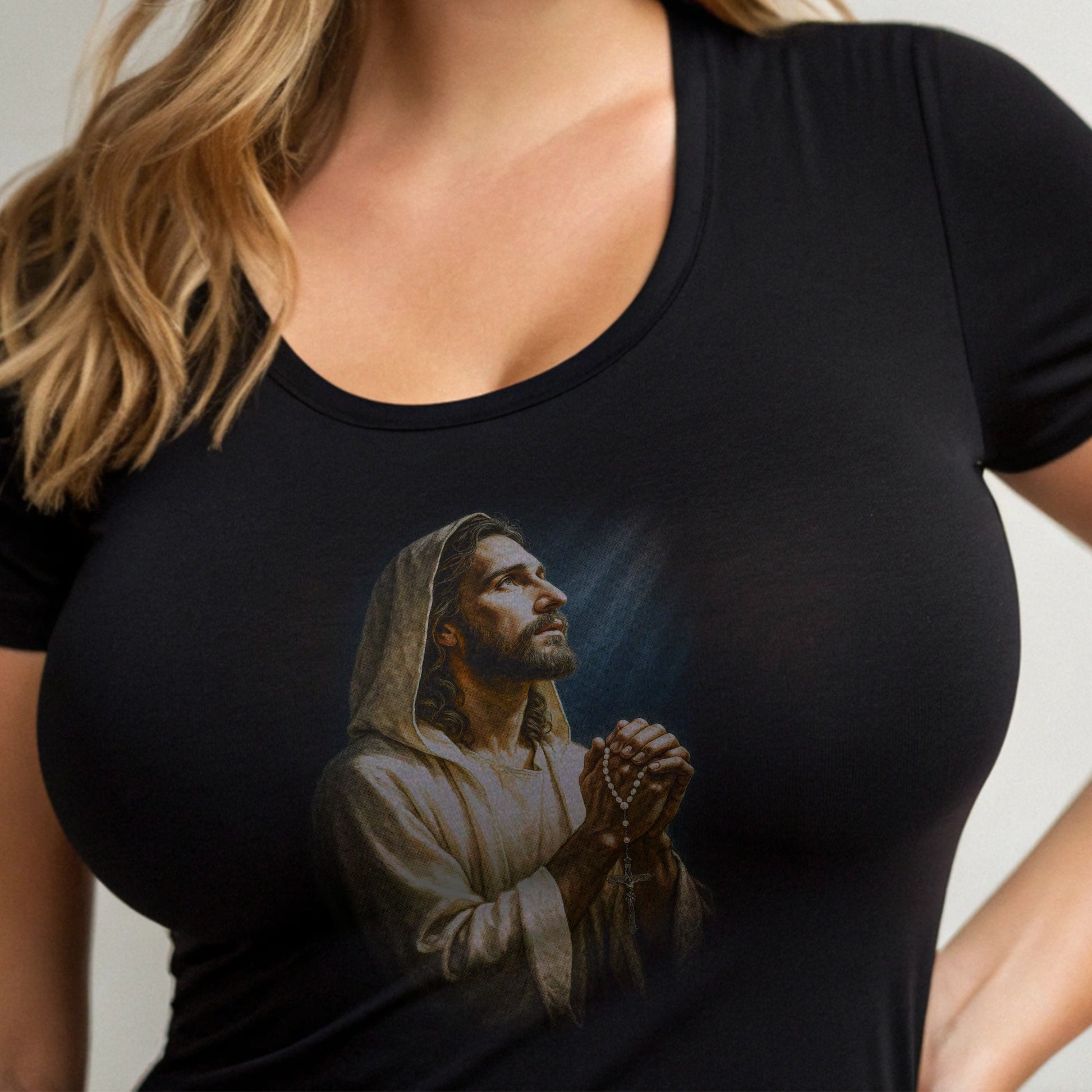 Jesus praying with rosary beads on a black t-shirt.