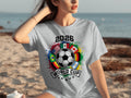 Gray t-shirt with 2026 World Cup logo featuring a soccer ball and flags.