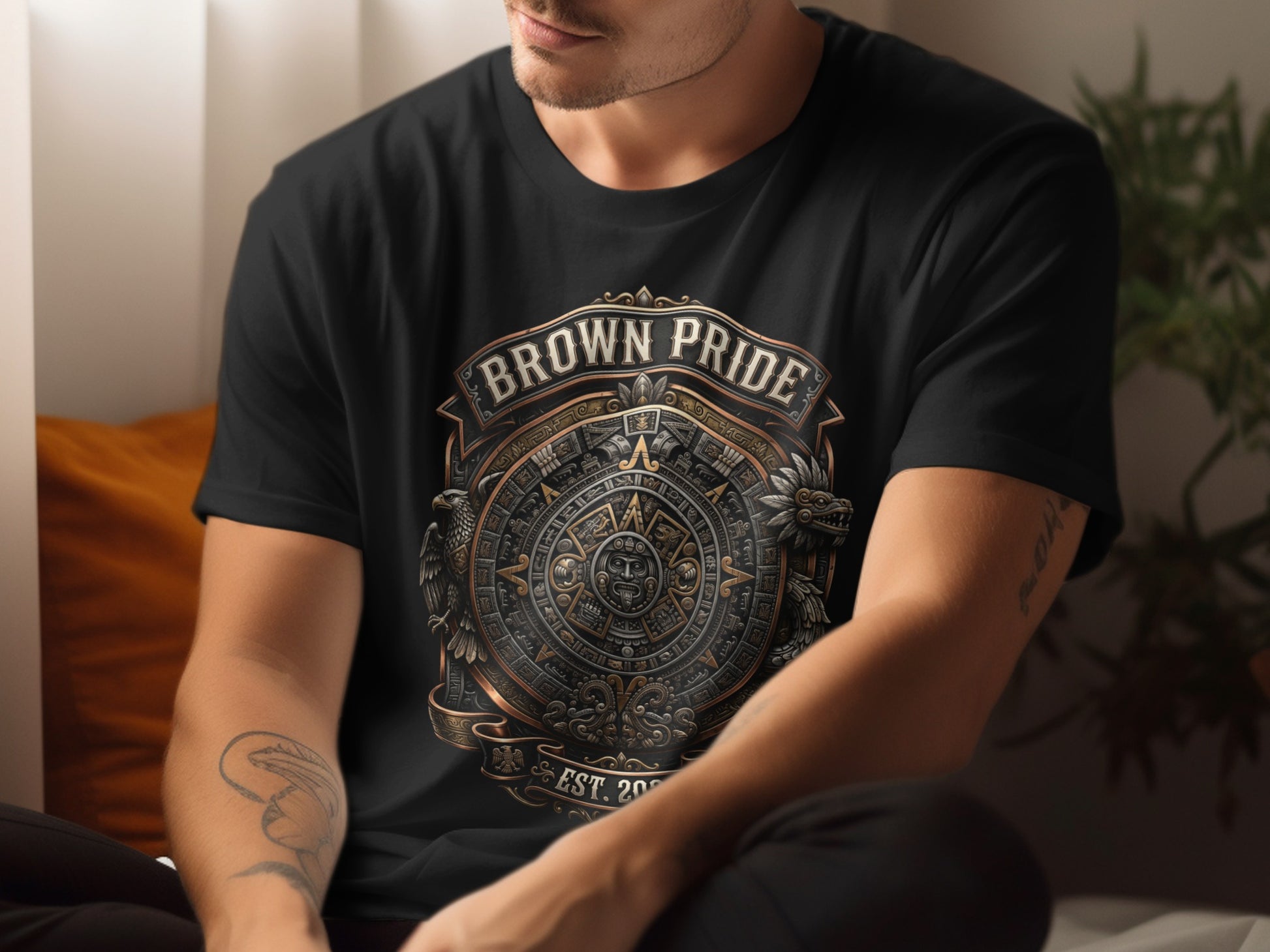 Black t-shirt with "Brown Pride" text and Aztec calendar design.