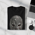 Black t-shirt with detailed metallic wrestler mask design, laid flat.