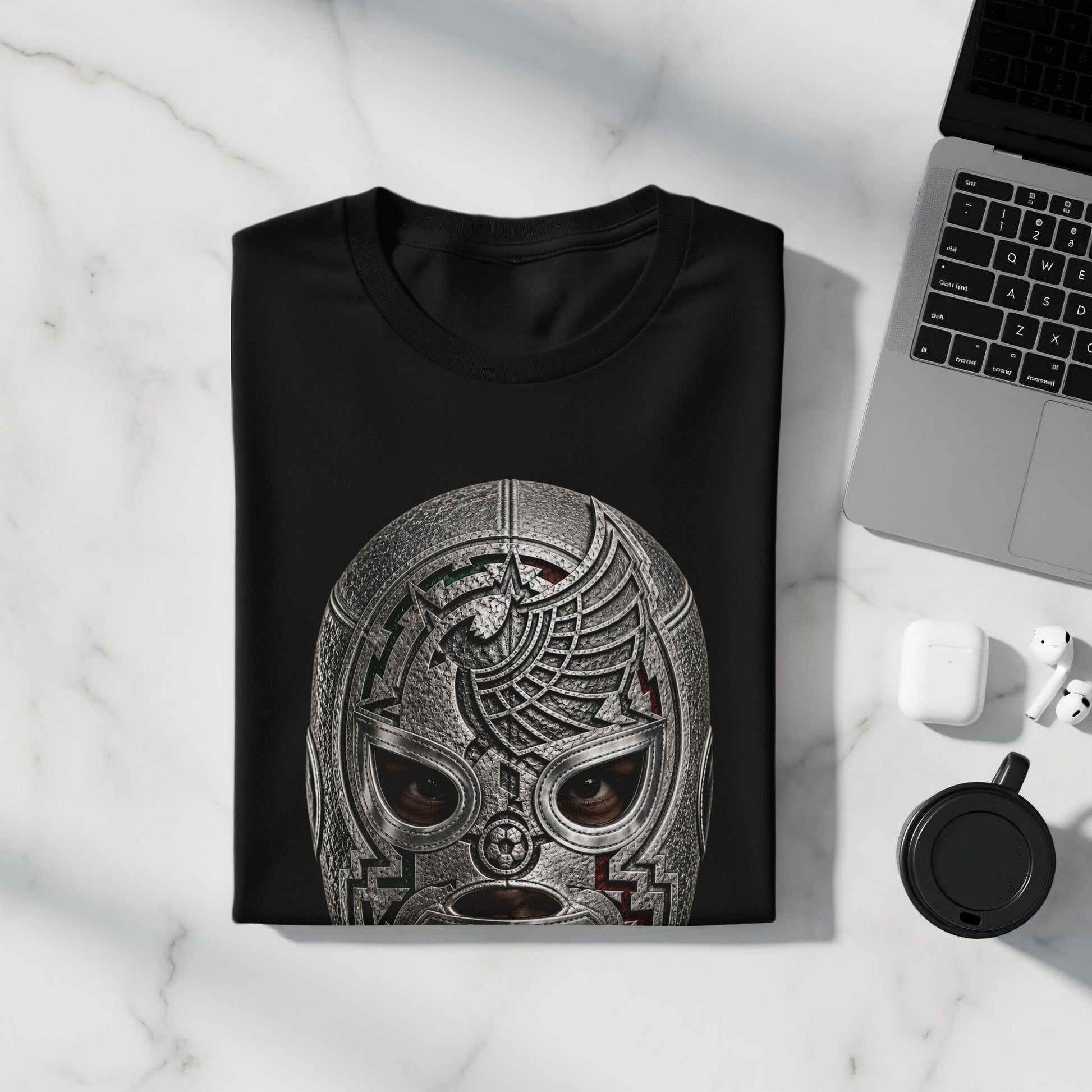 Black t-shirt with detailed metallic wrestler mask design, laid flat.